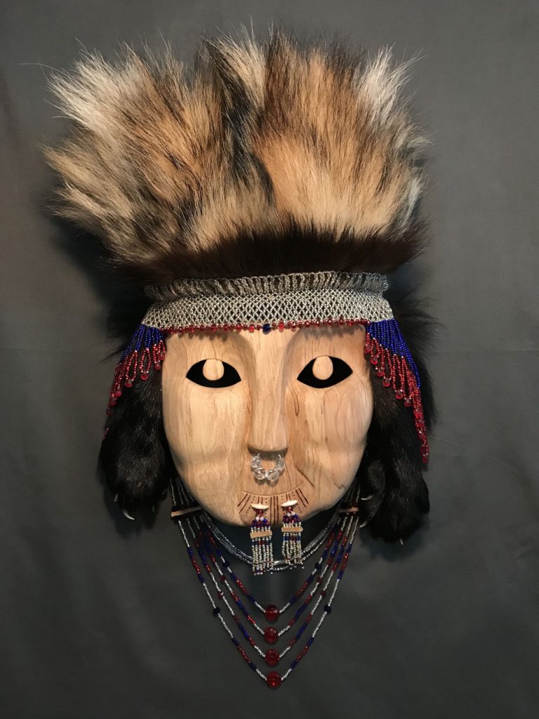 Jennifer Angaiak Wood 23”h x 12”w x 6 1/2”d Alder, seed beads, glass beads, ivory, moose hide, wolf and wolverine fur, wire. 2020
