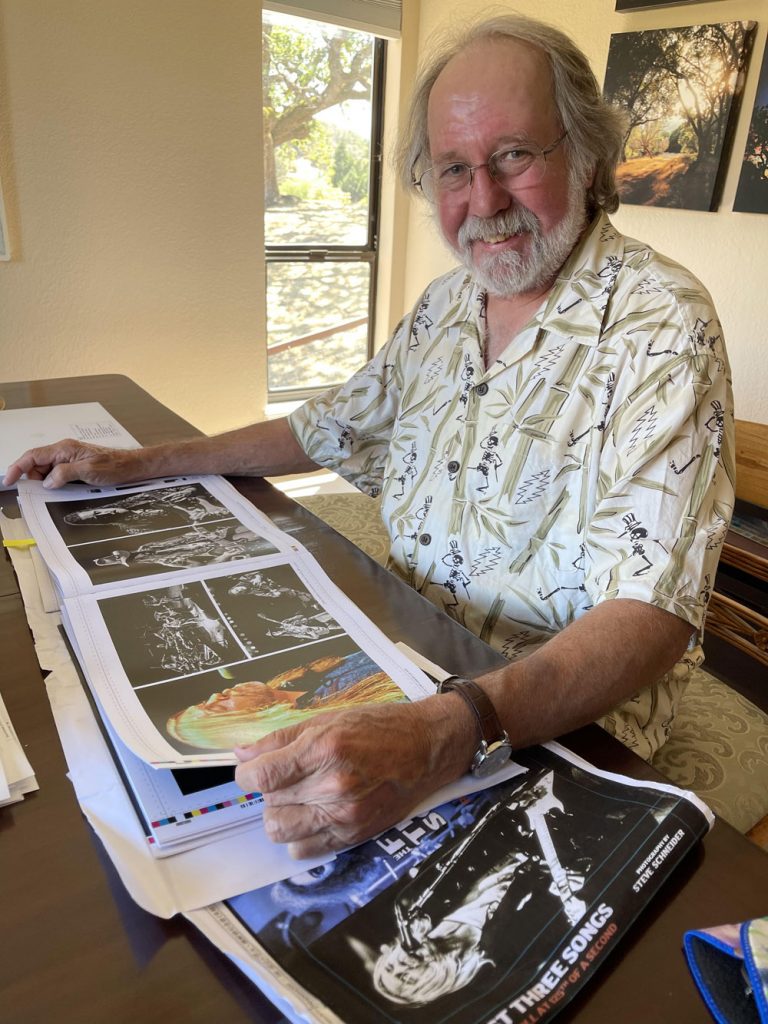 ”Steve Schneider with book proofs, 2021” Photo by Bob Minkin, 2021